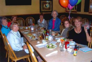 Volunteer Judy Ebling eating with Second Family team
